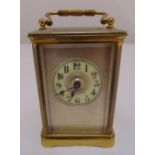A brass carriage clock with white enamel dial and Arabic numerals, 10.5 x 7.5 x 6cm