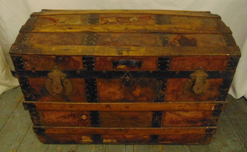 A late 19th century rectangular steamer trunk with metal and wooden bands and domed hinged cover, 55