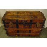 A late 19th century rectangular steamer trunk with metal and wooden bands and domed hinged cover, 55