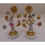 A pair of continental garnitures in the form of porcelain putti musicians within gilt metal floral