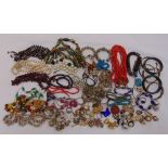 A quantity of costume jewellery to include necklaces, bangles and brooches
