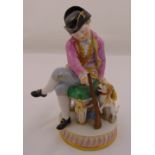 Meissen figurine of a boy with a toy gun and a dog, marks to the base incised F50, 13.5cm (h)