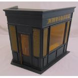 A wooden model of an antique shop with gilded lettering, hinged front door and pull off cover, 35.