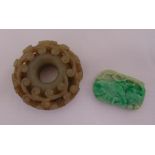 A circular brown jade pendant and green jade pendant of rounded rectangular form