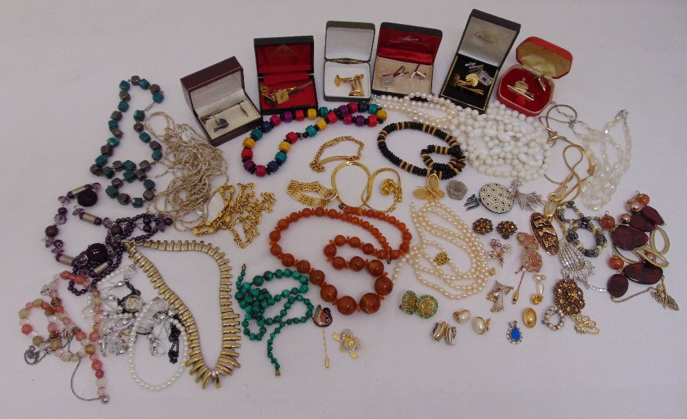 A quantity of costume jewellery to include brooches, necklaces, cufflinks and bracelets