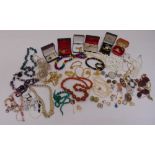 A quantity of costume jewellery to include brooches, necklaces, cufflinks and bracelets