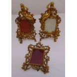 A pair of Art Nouveau gilded metal photograph frames surmounted by classical figurines frames and