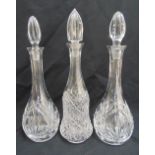Three cut glass decanters with drop stoppers, 40cm (h)