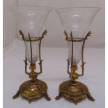 A pair of Art Nouveau style etched glass vases in bronze holders on raised circular bases and