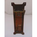 An early 20th century shaped rectangular brass and copper wall mounted stamp dispenser