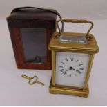 A brass carriage clock of customary form with white enamel dial and Roman numerals in original