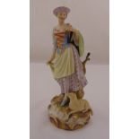 Meissen figurine of a shepherdess clutching a bouquet of flowers with a recumbent sheep at her feet,