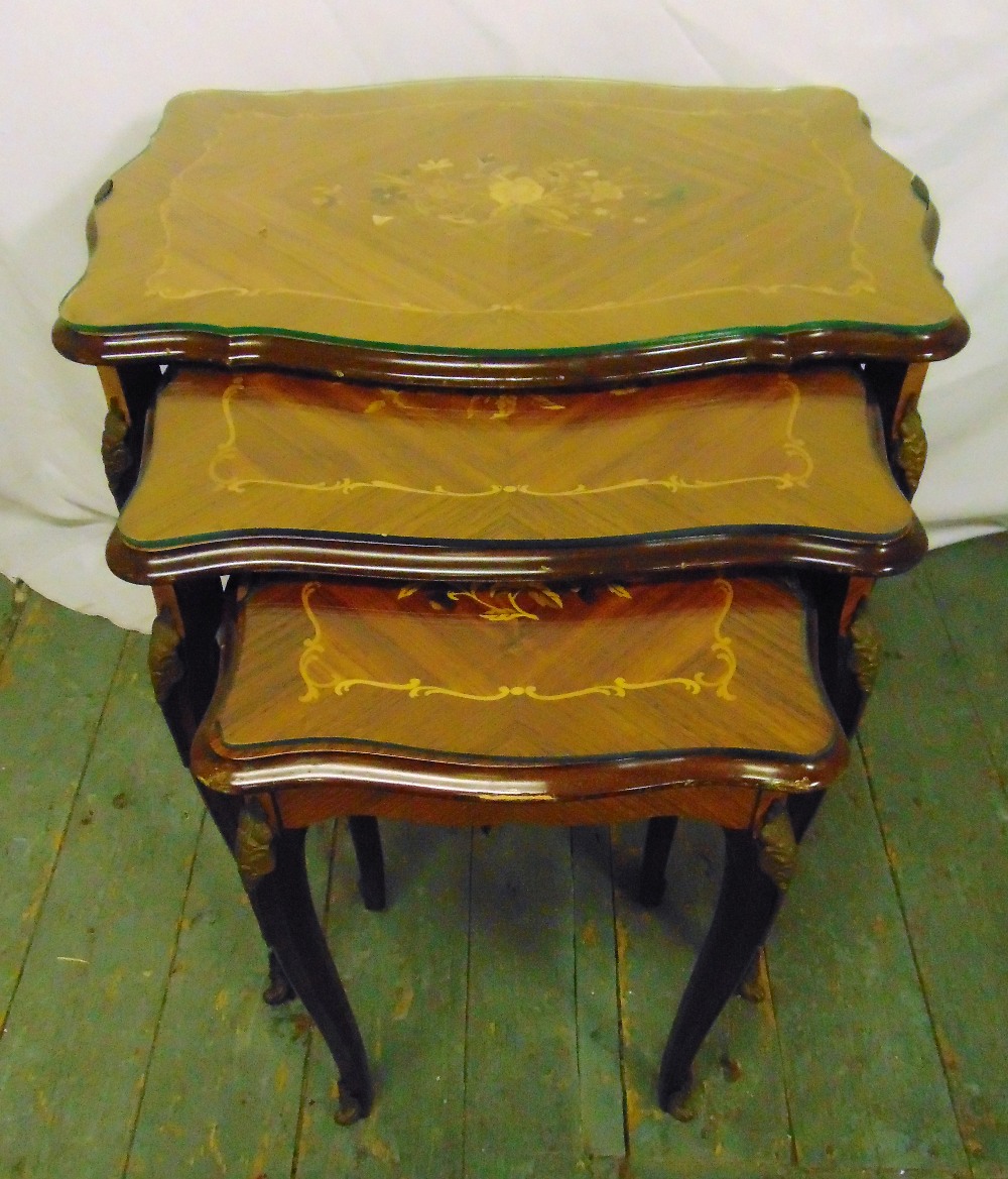 A nest of three shaped rectangular Kingswood tables with floral satinwood inlays to the tops, 59 x