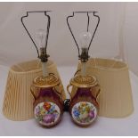 A pair of continental lamp bases, Viennese style, baluster form, decorated with floral sprays to