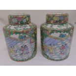 A pair of Chinese cylindrical famille verte vases with domed pull off covers, 32cm (h)