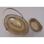 An oval bar pierced silver fruit basket with pierced swing handle on raised oval bar pierced foot,