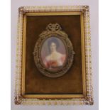 A portrait miniature of a lady in ornate gilt metal frame, indistinctly signed, 8x 6cm