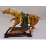 A polychromatic oriental model of a Tang Horse on rectangular wooden stand, 32 x 45cm