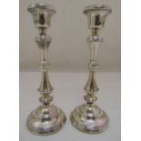 A pair of silver table candlesticks of knopped cylindrical ribbed form on raised circular bases,