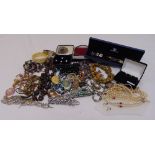A quantity of costume jewellery to include brooches, necklaces, bracelets and a watch