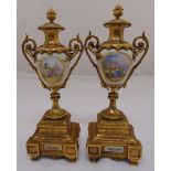 A pair of French 19th century gilt metal and porcelain urns decorated with figures in 18th century