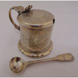 A Victorian silver mustard pot cylindrical, the sides engraved with leaves and scrolls and a mask