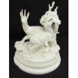 KPM Berlin blanc de chine figural group of deer within foliage on shaped oval base, signed E