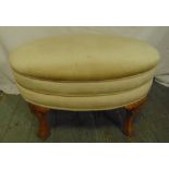 A mahogany oval upholstered bedroom stool on four carved bracket supports, 45 x 71 x 46cm