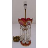 A continental pink glass lustre with faceted drops on raised circular base converted to an