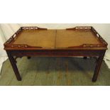 A Chinese style rectangular coffee table with pierced gallery and leather top opening to reveal a