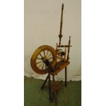 A vintage upright Castle-style spinning wheel of customary form, 135 x 70 x 28cm