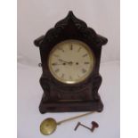 A Victorian mahogany bracket clock, shaped rectangular with leaf and scroll carved swags