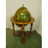 A globe drinks stand on four turned legs and castors, 96cm (h)