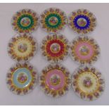 Nine vari-coloured Vienna fruit plates, the centres decorated with courting scenes