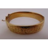 A 9ct gold metal core leaf motif bangle, approx total weight 21.3g