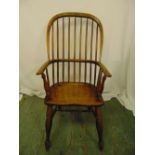 A 19th century oak Windsor chair on turned cylindrical legs