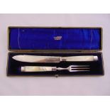 A Victorian cased silver plated and mother of pearl carving knife and fork with silver ferules,
