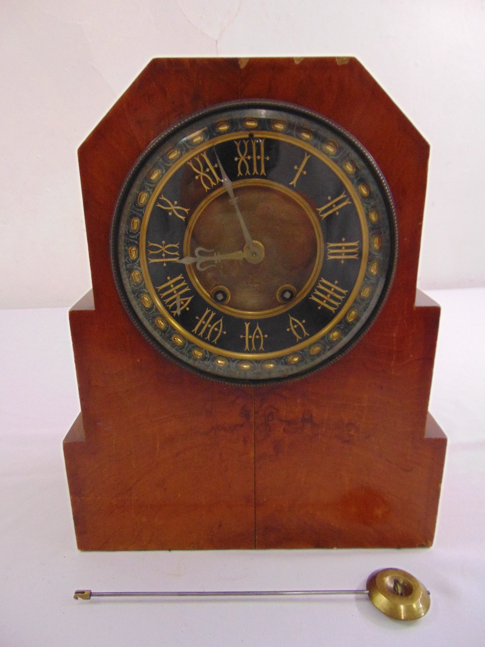 An Art Deco wooden mantle clock two train movement, silvered dial, enamel chapter ring with Roman
