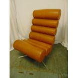 A mid 20th century brown faux leather (sausage) chair of tubular sections on triform metal base