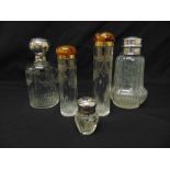 A quantity of scent bottles two with 9ct gold and tortoiseshell covers, three with white metal