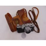 Leica camera in fitted leather case with original lens and labels