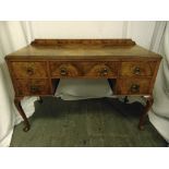 A late Victorian walnut rectangular dressing table with five drawers on cabriole legs