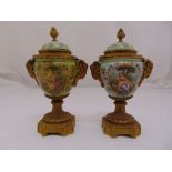 A pair of 19th century continental porcelain and gilt metal urns and covers, twin rams head handles,