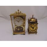 A Schatz gilt metal and glass revolving pendulum mantle clock and a miniature brass lantern clock in