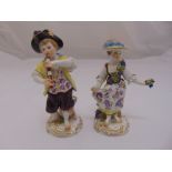 Two Meissen figurines of a boy playing a flute and a girl holding grapes, slight loss to stem,