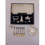 A quantity of silver to include a cased condiment set, coffee spoons, an ashtray and a napkin