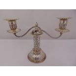 A Victorian silver two branch candelabrum, of tubular form on raised circular base, leaf and