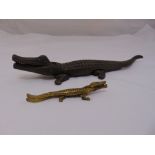 A bronze nutcracker in the form of crocodile and a smaller brass nutcracker in the form of a