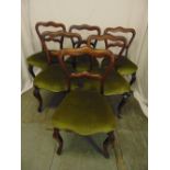 A set of six Victorian rosewood balloon back upholstered dining chairs on cabriole legs