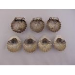 Three Victorian silver salts of shell form on serpent feet, London 1863, and four silver shell